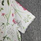 SpringStil® - Garden Print V-Ausschnitt Weißes Maxi-Sommerkleid