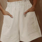 Emilia - Beigefarbene Leinenshorts mit Taschen